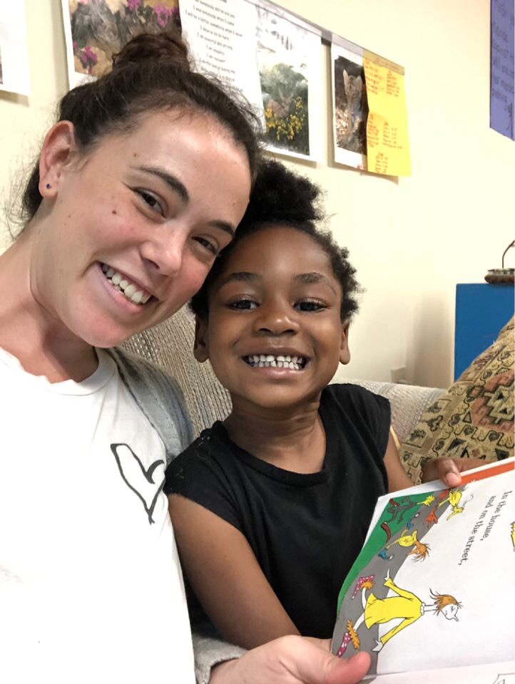 A camp counselor and a camper smiling together