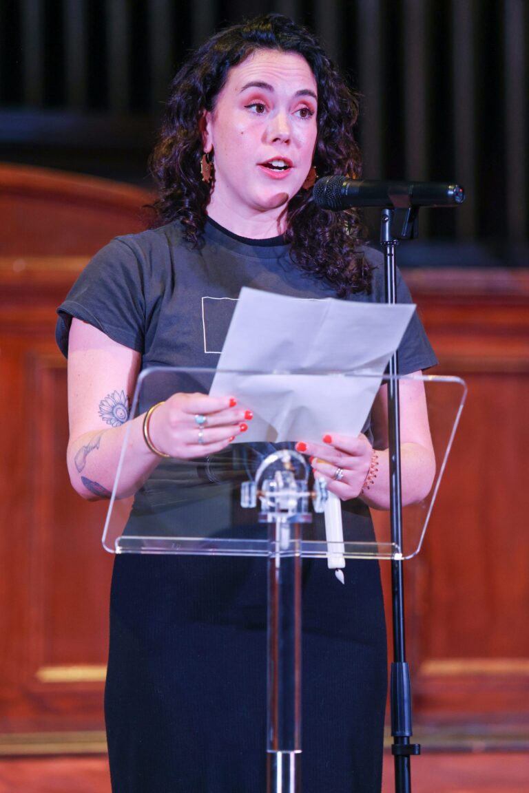 A speaker reads remarks at the lectern