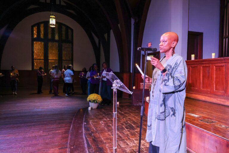 A speaker at the microphone, with the sanctuary behind her