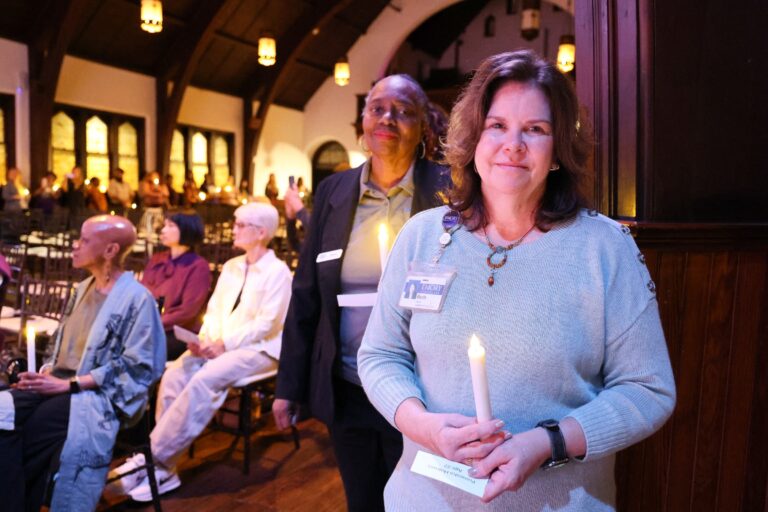 Candle bearers stand beside the audience