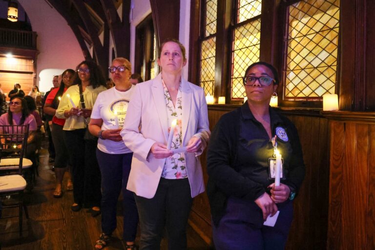 Candle bearers line up along the aisle