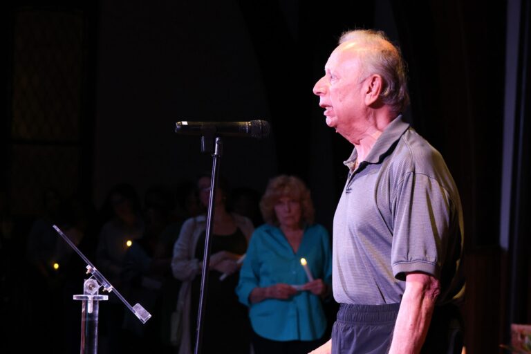 A speaker addresses the gathering at the microphone