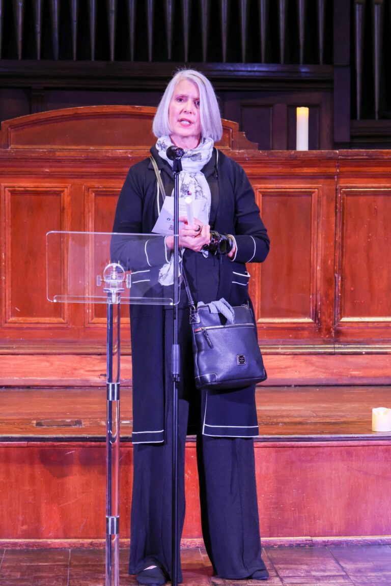 A speaker stands at the lectern