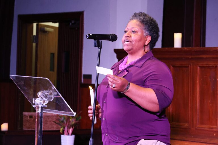 A speaker in purple shares remarks