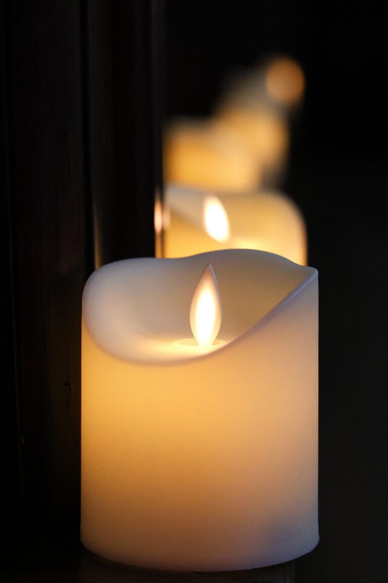 A single candle glowing in the dark