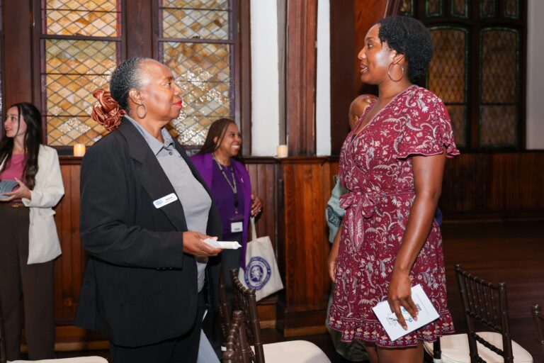 Attendees talk together after the program