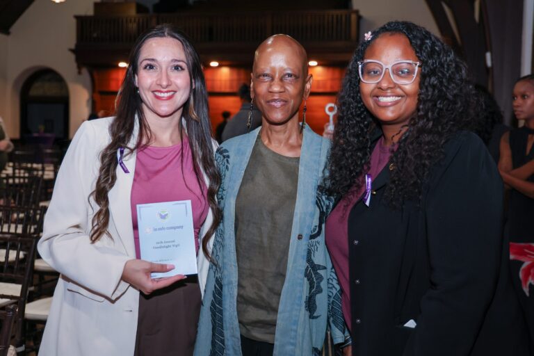 Three attendees pose together after the vigil